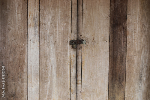 lock on the wooden door of an old farmhouse