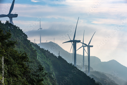 Windmill in the rainy season in the missing mountain in Heyuan, Guangdong, China photo