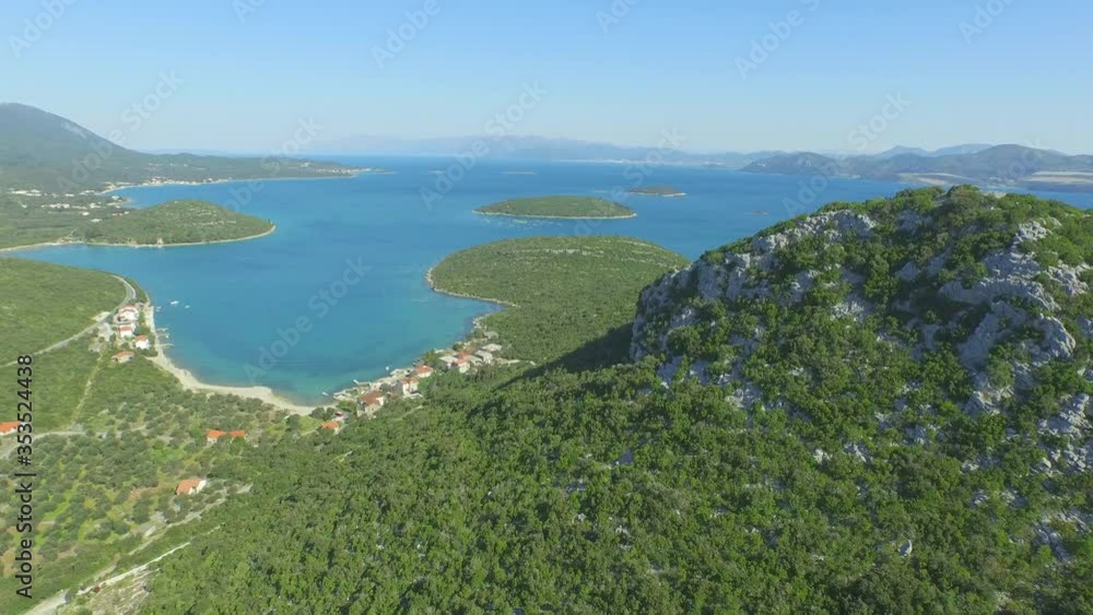 Aerial beautiful landscape against sky on sunny day, drone is moving forward - Ston, Croatia Aerial beautiful landscape against sky on sunny day, drone is moving forward - Ston, Croatia