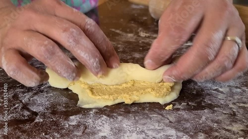 Rolling the spanish bread dough in a breadcrumbs