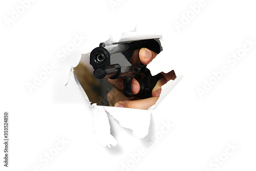 Men's hand with a gun. Crime concept. man's hand holding a black pistol gun, isolated on white, close-up, mockup for layout. Man's hand holding a black gun, aiming. Violence with weapons. Street gangs