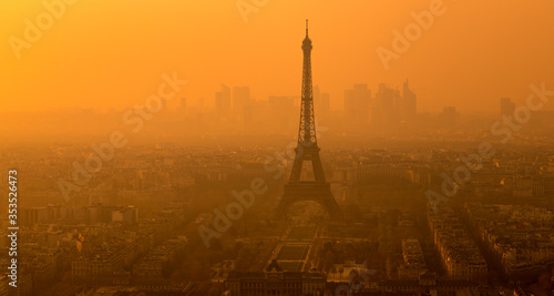 Eiffel Tower at the distant, in a foggy sunset. Paris, France