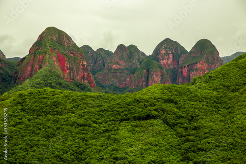 Pristine Red Rock Mountain Range Covered of Forest of Amboro National park, Bolivia on a Cloudy Day photo