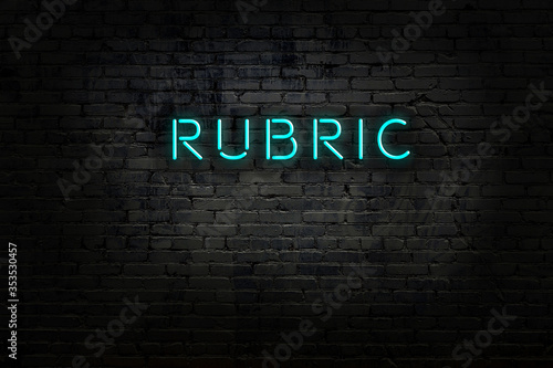 Neon sign with inscription rubric against brick wall