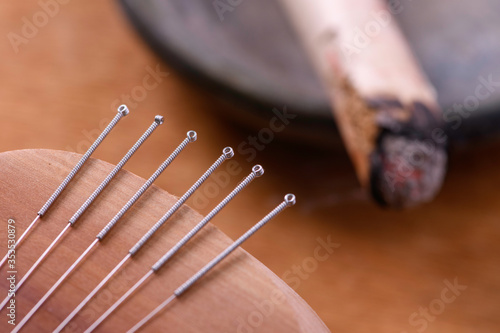 Traditional China acupuncture needles and moxa stick photo