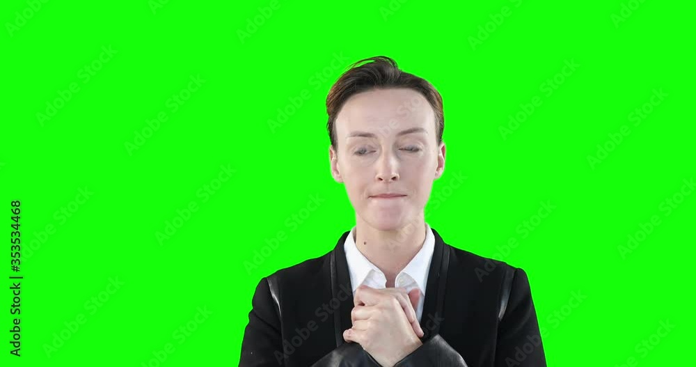 Anxious Caucasian woman looking at camera on green background Anxious Caucasian woman looking at camera on green background