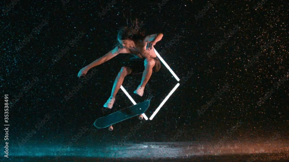 Amazing skilled skateboard hardflip trick in wet rain studio effect, caucasian man Amazing skilled skateboard hardflip trick in wet rain studio effect, caucasian man