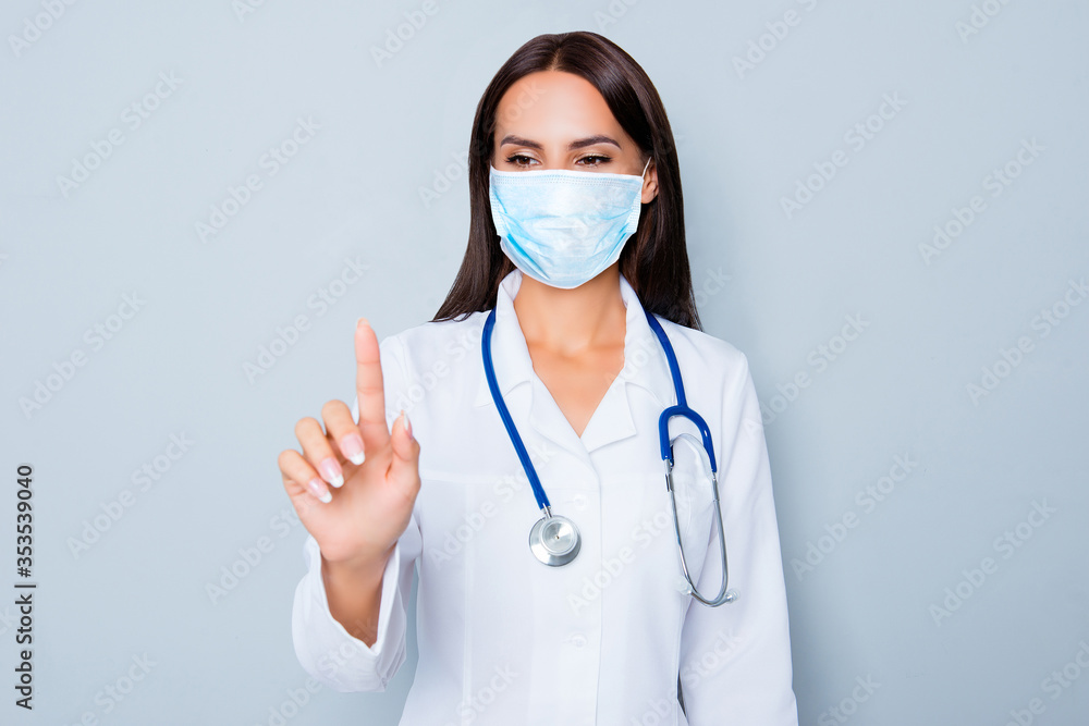 Female doctor in white uniform touching virtual screen wear medical safety sterile mask on face, stop pandemic corona virus prevention protection concept 2020 covid 19 Female doctor in white uniform touching virtual screen wear medical safety sterile mask on face, stop pandemic corona virus prevention protection concept 2020 covid 19