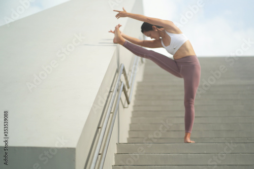 Street Yoga - Asian Chinese Woman doing yoga in public spaces