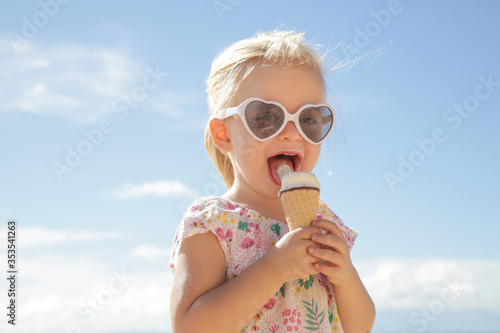 Photography Adorable toddler girl eating ice cream