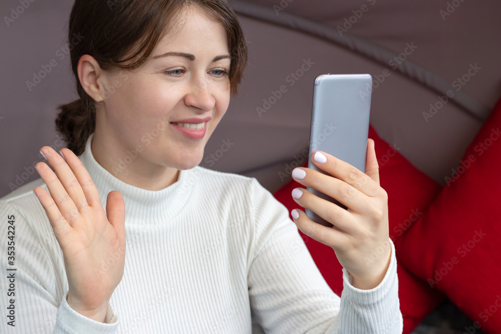 Beautiful young girl looking at smartphone and smiles, blogger work concept. Beautiful young girl looking at smartphone and smiles, blogger work concept.