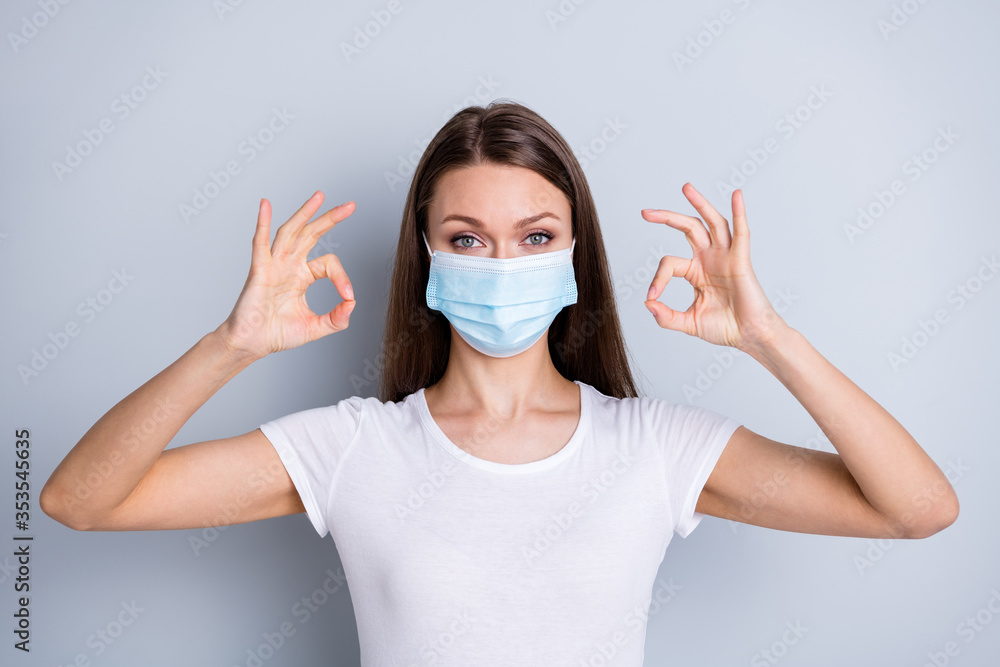 Portrait closeup photo of pretty lady keep social distance people contacting had hospital examination healthy show okey symbols wear protect face medical mask isolated grey color background Portrait closeup photo of pretty lady keep social distance people contacting had hospital examination healthy show okey symbols wear protect face medical mask isolated grey color background