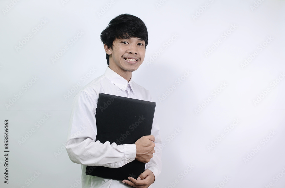 A man carrying a laptop. Young Asian men wearing white shirts isolated on a white background
A man carrying a laptop. Young Asian men wearing white shirts isolated on a white background