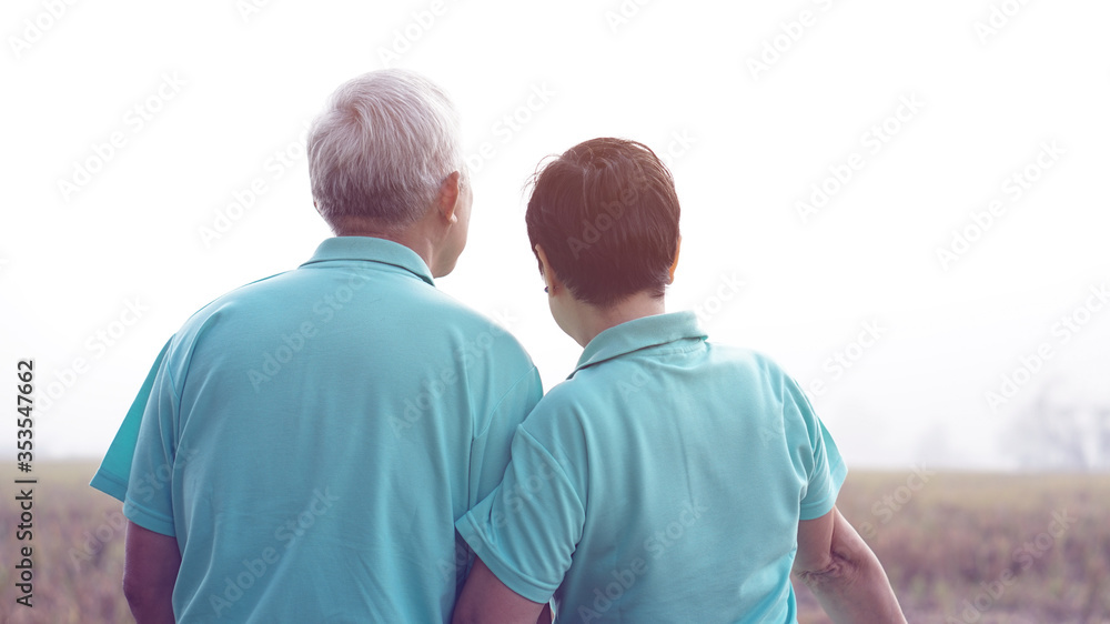 Fototapeta premium Asian elderly stand with their farm after harvested at the end of season