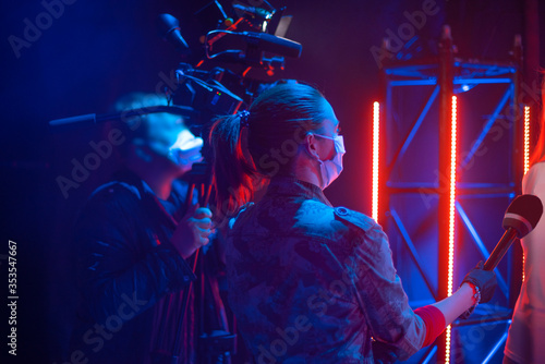 Photography masked journalists filming interviews during a pandemic