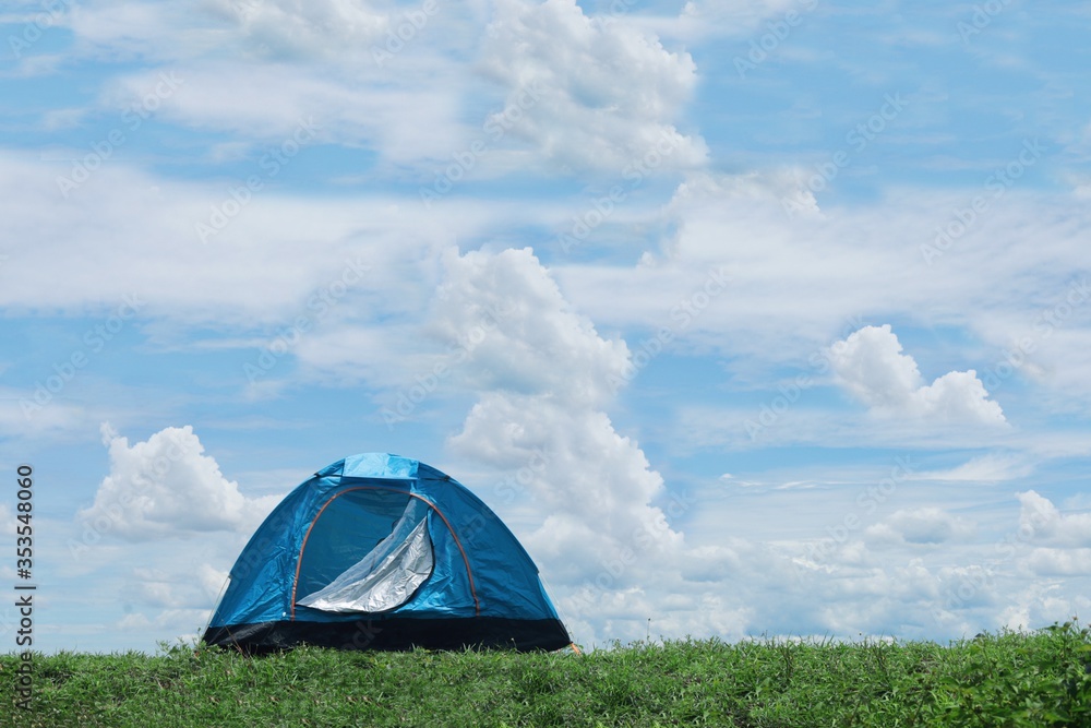 Traveler tent no the mountain with blue sky background.