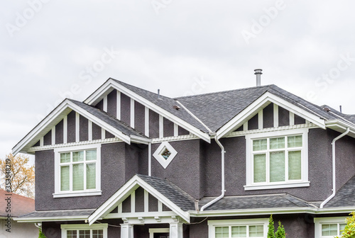 The top of the house or apartment building with nice window.