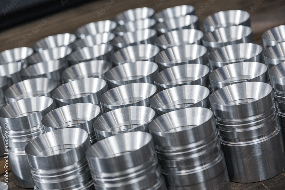 Closeup of shiny circular steel metal part made on lathe. Metal industry products, workpieces. Steel products to automotive industry. Billet obtained on lathe from steel and cast iron Closeup of shiny circular steel metal part made on lathe. Metal industry products, workpieces. Steel products to automotive industry. Billet obtained on lathe from steel and cast iron