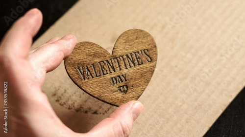 Fotografie Hand of master holds the finished product Valentine Day symbol phoner heart