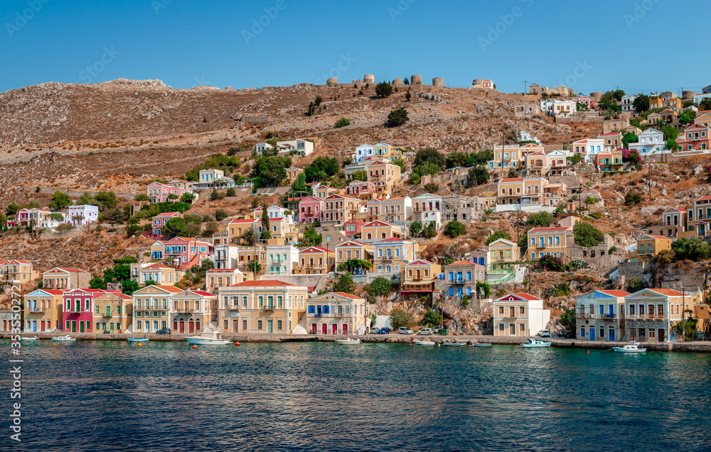 Symi / Greece - August 17 2017: View of the waterfront. Symi (or Simi) is a tiny island of Dodecanese, that amazes visitors with its calm atmosphere and fabulous architecture.