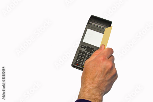 The hand holds a credit card on the payment terminal. Isolated on white background