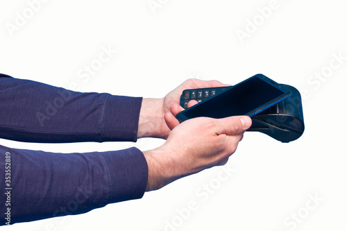 Male hand using contactless payment terminal with smartphone on white background