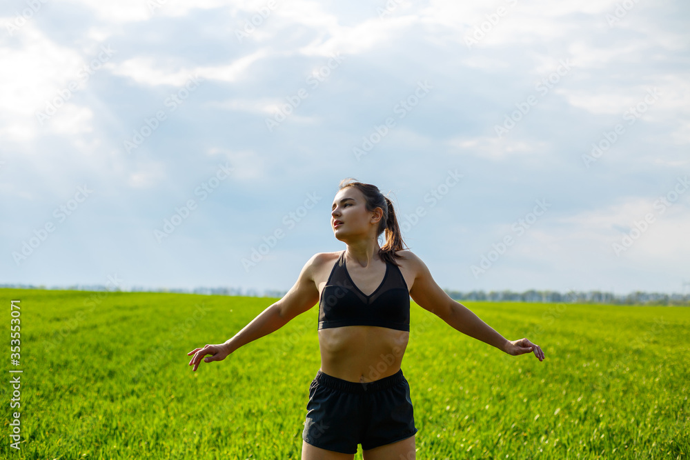Morning workout. Healthy lifestyle concept. Young attractive woman in sportswear makes stretching her hand before training on the nature at dawn. Muscle warming Morning workout. Healthy lifestyle concept. Young attractive woman in sportswear makes stretching her hand before training on the nature at dawn. Muscle warming