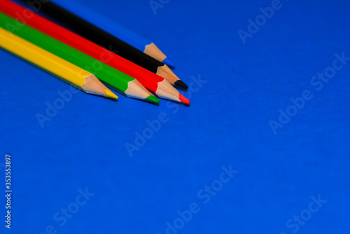 This is a stock photo that shows colored pencils on a blue background.