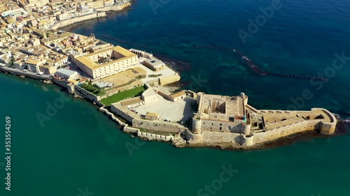 Siracusa, Ortigia Island from the air, Sicily, Italy. Isola di Ortigia, coast of Ortigia island at city of Syracuse, Sicily, Italy. Coastline town Syracuse, Sicily and old Ortigia island. Aerial view. photo