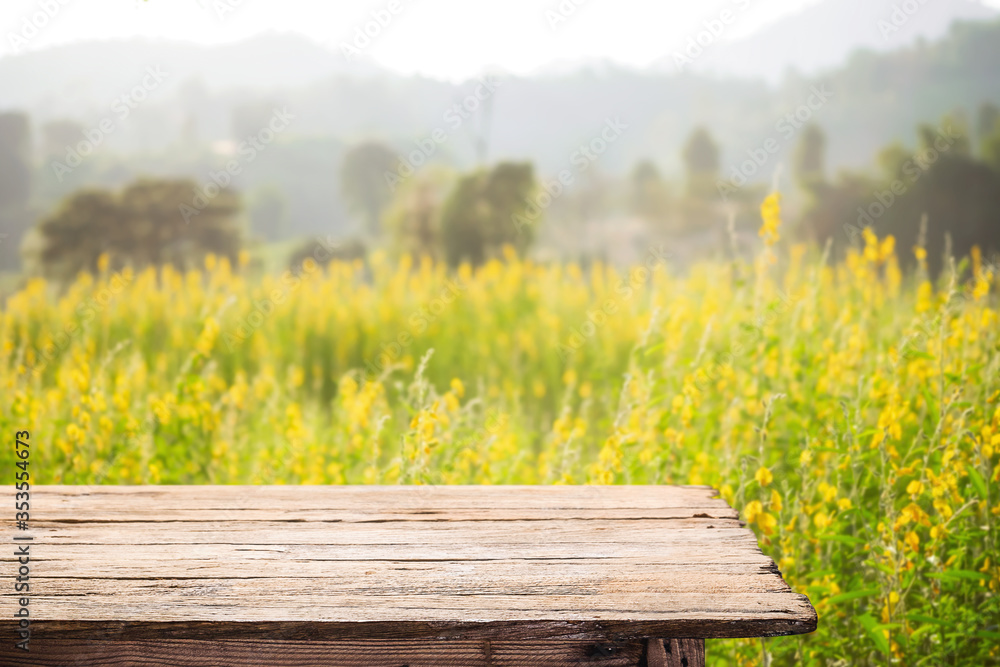 Fototapeta premium Empty wooden table space platform and blurred field or farm background for product display montage