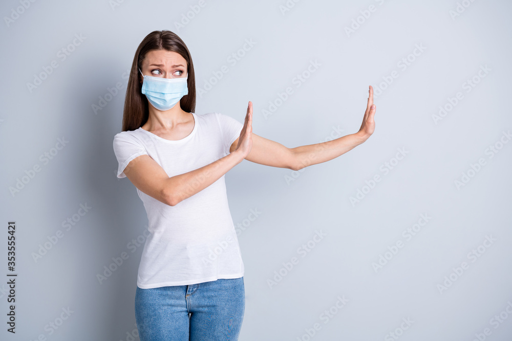 Too close. Photo of serious lady keep social distance avoid afraid of people contact raise arms side empty space stand two meter wear protect face mask isolated grey color background - obrazy, fototapety, plakaty 