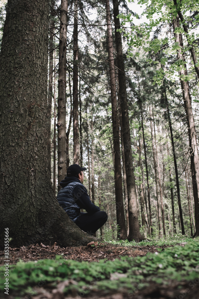 Traveler man relaxing in forest with photo camera, backpack. Travel lifestyle concept vacations outdoor. Traveler man relaxing in forest with photo camera, backpack. Travel lifestyle concept vacations outdoor.