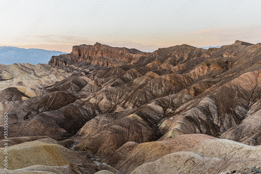 Zabriskie point sunset travel destination in California. A pattern from rocky colorful mountains in Death Valley