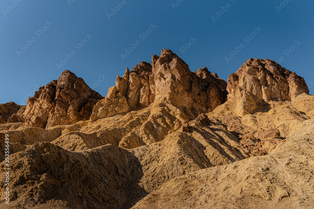 Golden Canyon in Death Valley National Park in the USA. Textured rocky golden peaks in Golden Canyon California 