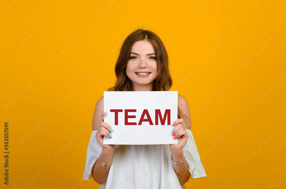 Dark-haired young woman with a smile and big suprised eyes posing on yellow background. Dark-haired young woman with a smile and big suprised eyes posing on yellow background.