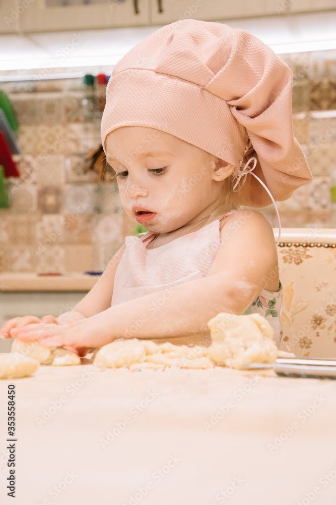 Little girl cooks at home in the kitchen Little girl cooks at home in the kitchen
