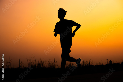 Black silhouette taken from exercise at sunset,running