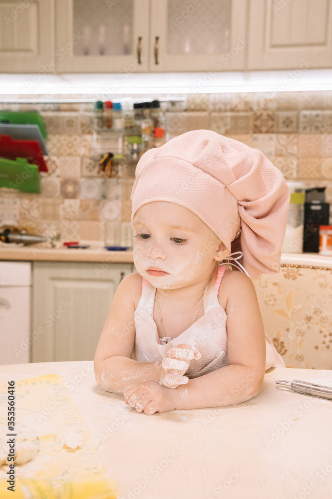 Little girl cooks at home in the kitchen Little girl cooks at home in the kitchen