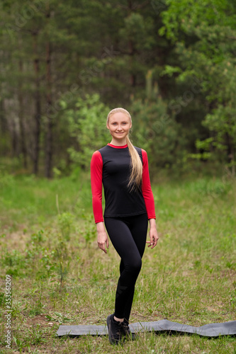 Sportive girl posing in forest