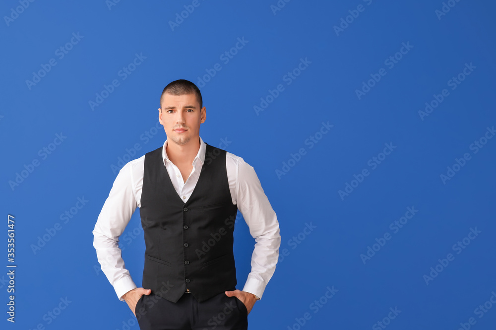 Handsome young man in elegant suit on color background Handsome young man in elegant suit on color background