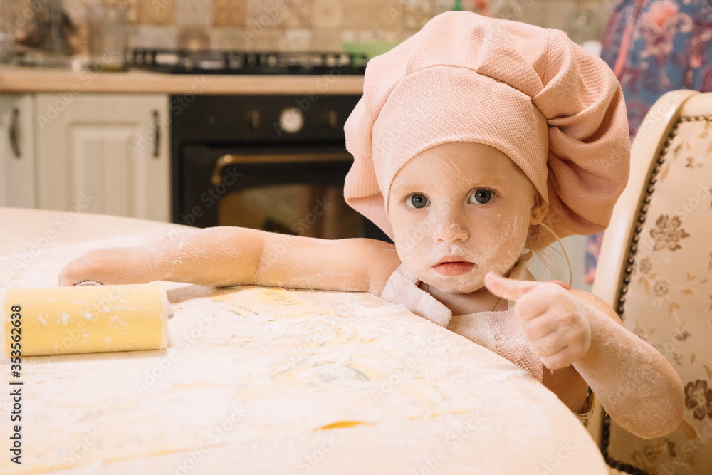 Little girl cooks at home in the kitchen Little girl cooks at home in the kitchen