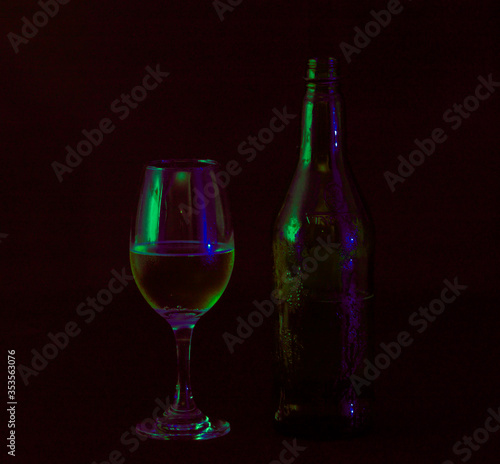  glass with bottle of wine in the dark