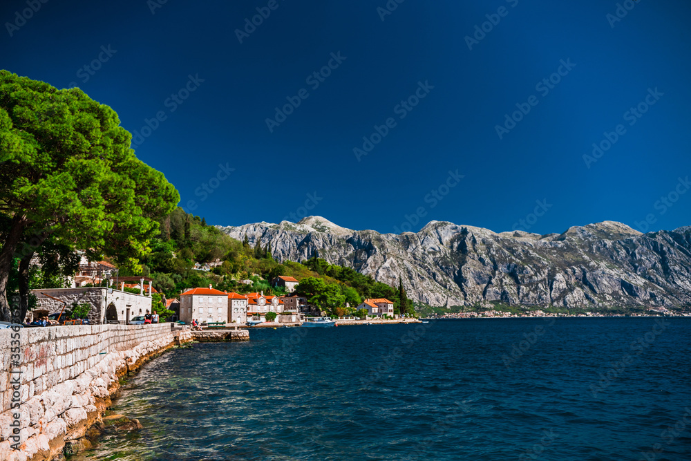 Embankment in the small town of Perast in Montenegro. Old buildings on the shore of the Bay of Kotor.