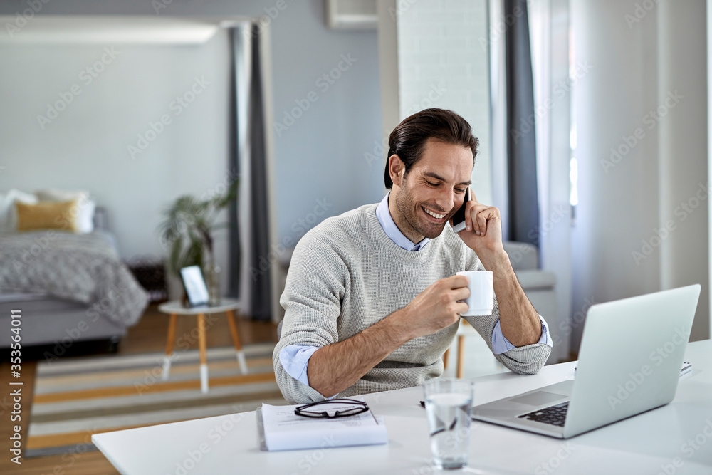 Happy entrepreneur talking on the phone while working at home. Happy entrepreneur talking on the phone while working at home.