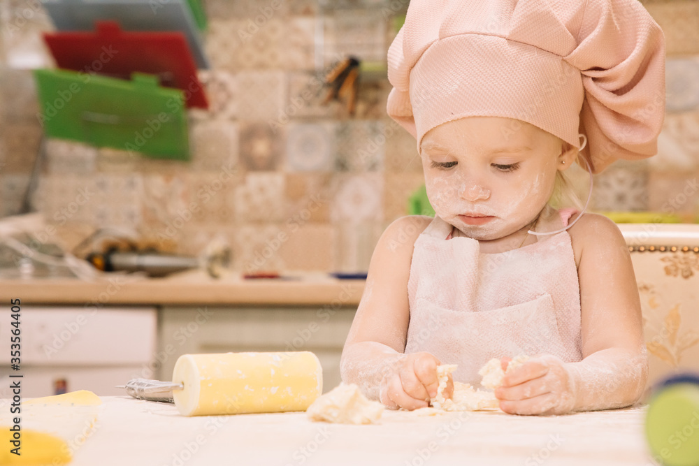 Little girl cooks at home in the kitchen Little girl cooks at home in the kitchen