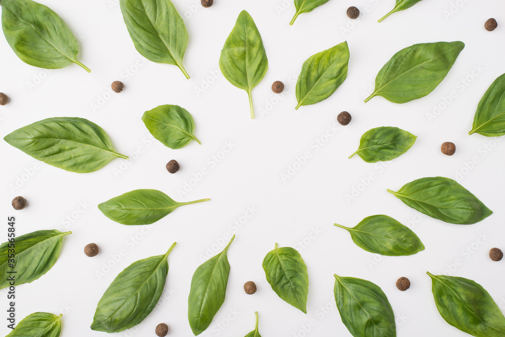 Top above overhead view photo of basil leaves and peppercorns isolated on white background Top above overhead view photo of basil leaves and peppercorns isolated on white background