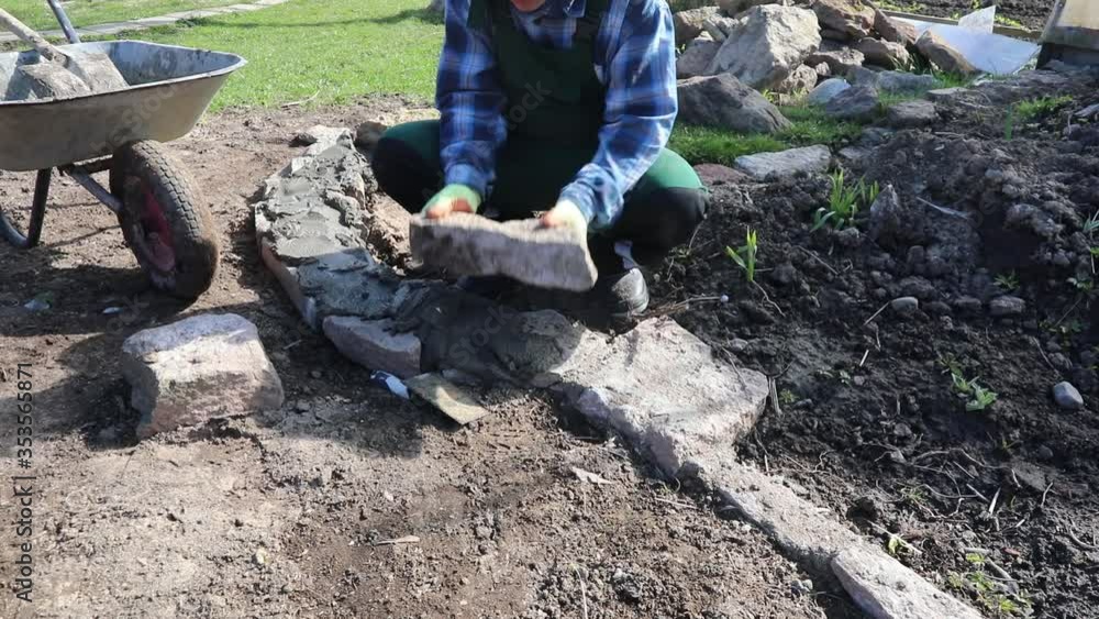 A man makes an Alpine rock garden. Step-by-step instructions. A man makes an Alpine rock garden. Step-by-step instructions.