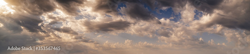 Colourful morning sky with clouds and sunrays (wide skyscape background panorama).