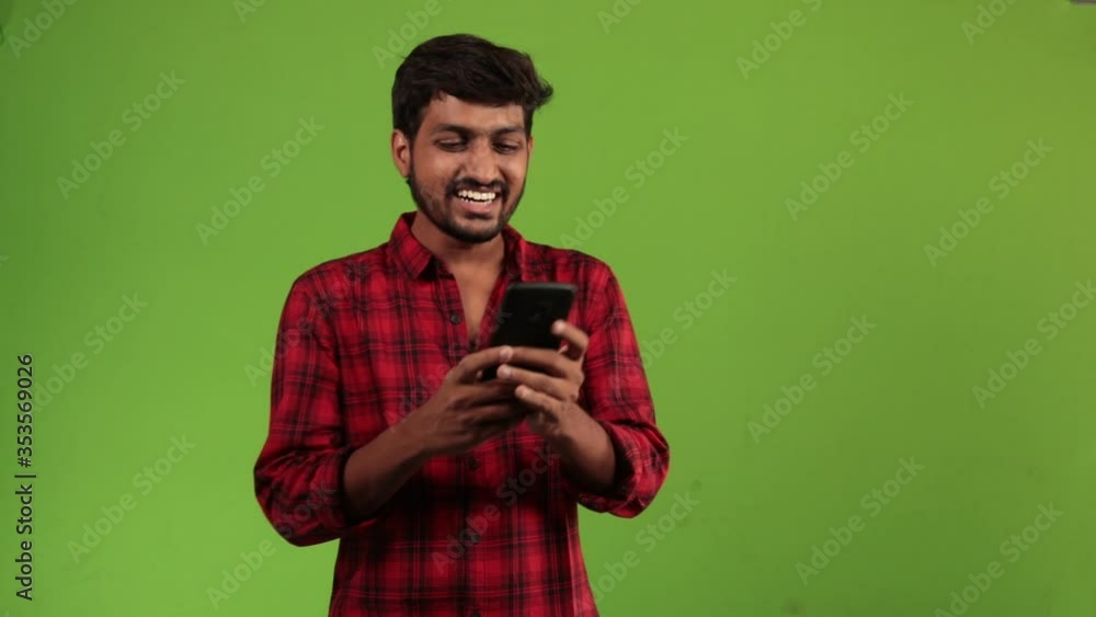 Indian businessman typing message on mobile phone. Handsome man in white shirt using cell phone on Chroma Key background. Indian businessman typing message on mobile phone. Handsome man in white shirt using cell phone on Chroma Key background.