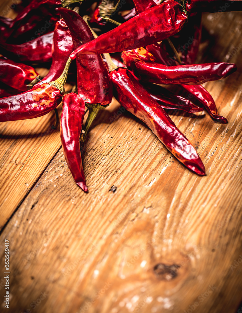 Dry red chilli pepper on wooden table